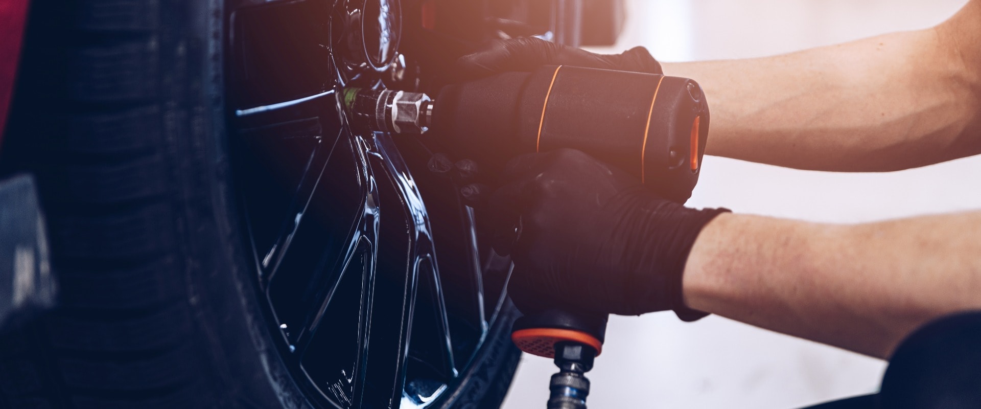 Changing car tire and wheel in the professional car mechanical service