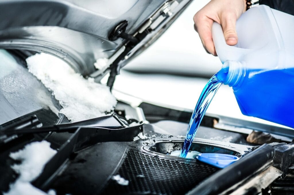 Pouring antifreeze. Antifreeze liquid for washing car screen.
