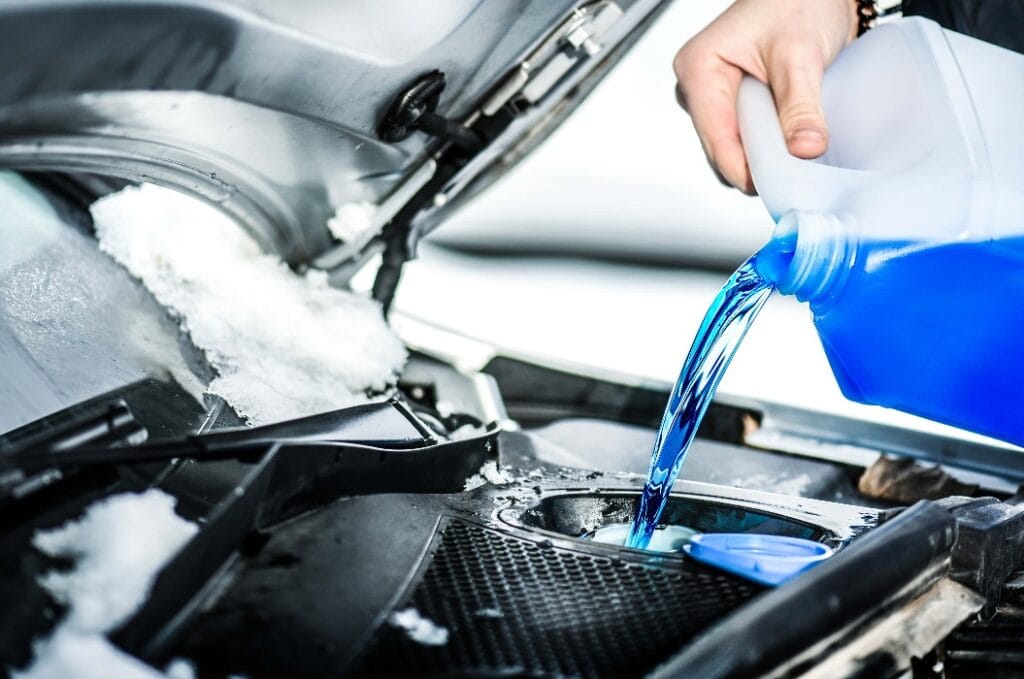 Pouring antifreeze.  Antifreeze liquid for washing car screen.